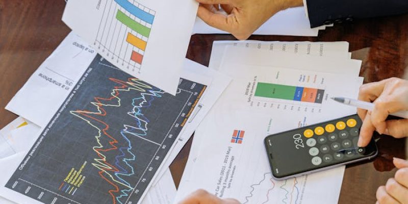 Business professionals analyzing financial charts and graphs during a meeting.